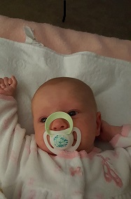 This is the newest addition to our family. Age 10 weeks. Note the +20 paci of peace and quiet. Now to work on her sisters..........